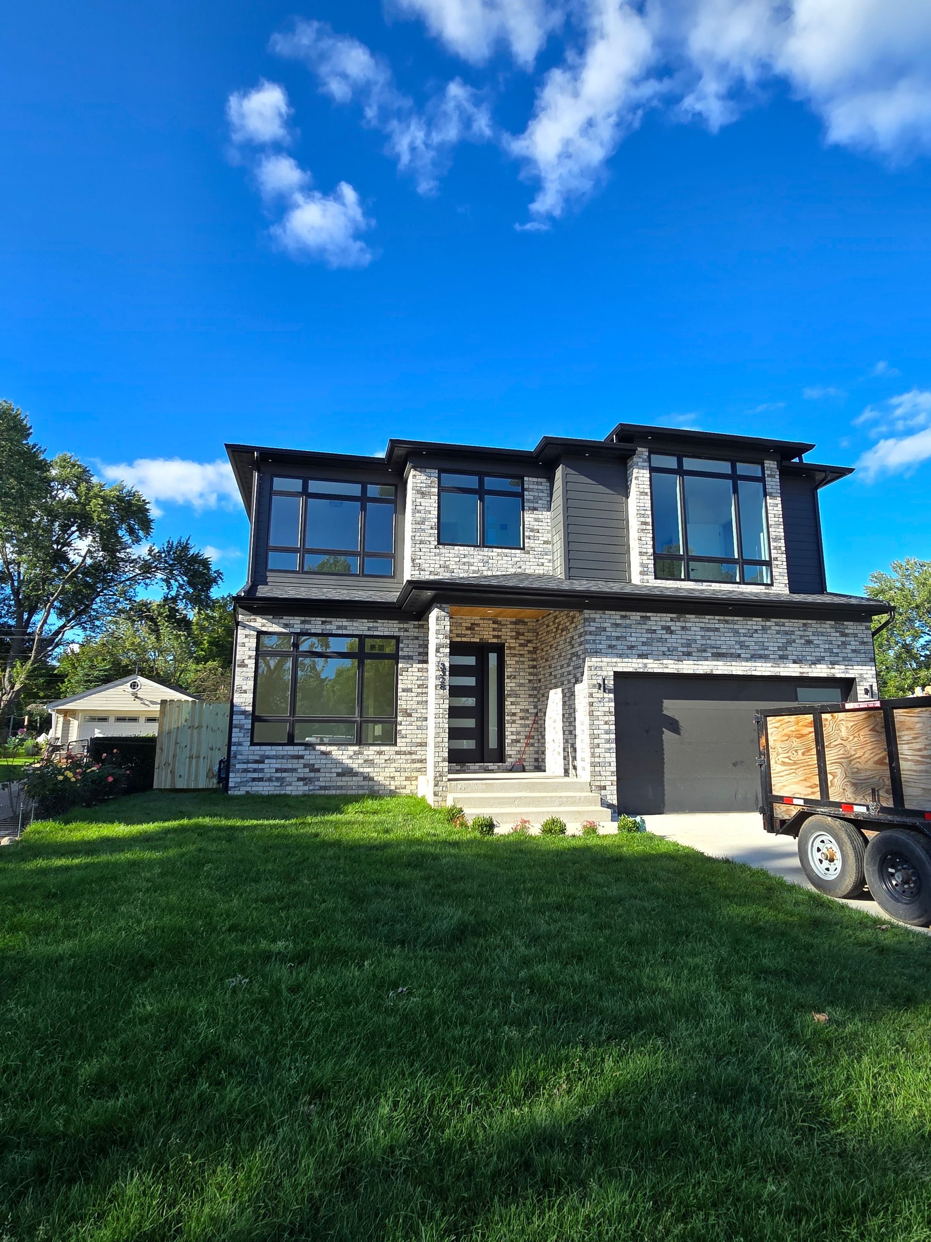 A large house with a truck parked in front of it.