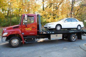 White Car On Towing Truck — Nashville, TN — Mike’s Custom Towing