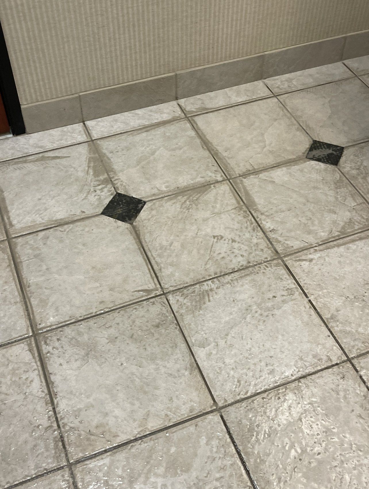 A close up of a tiled floor in a room.