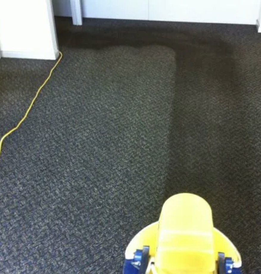 A yellow toy is sitting on a carpeted floor