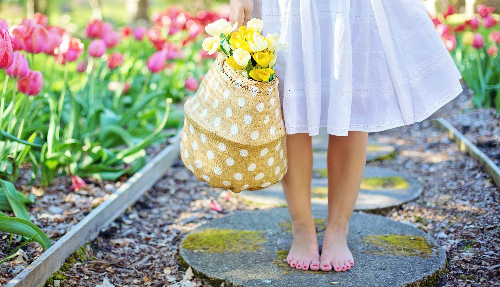 young girls bare feet in spring garden