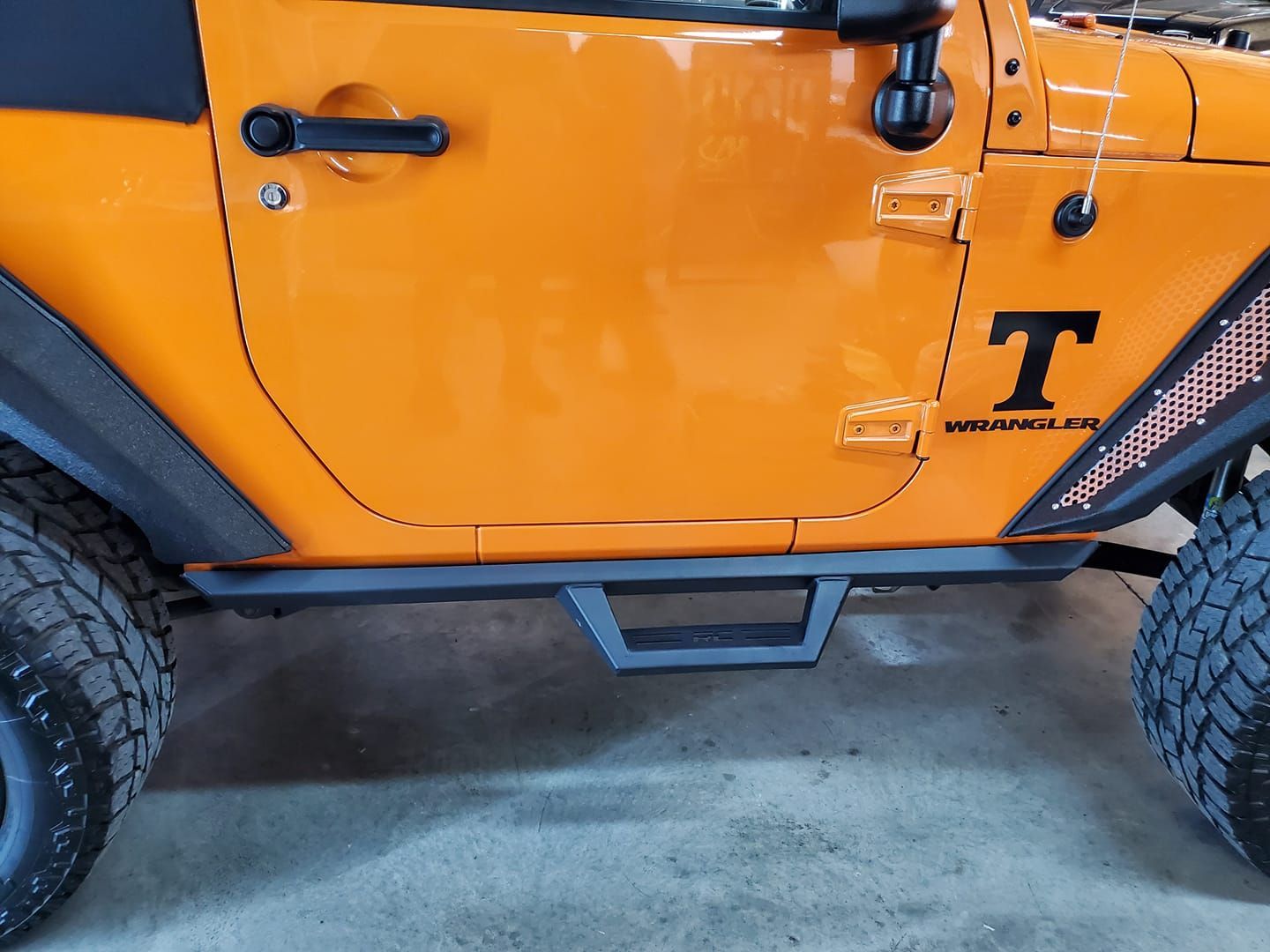 Orange truck with bars - Dalton, GA - Mark's Auto Glass & Custom, Inc.