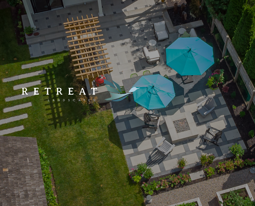 An aerial view of a patio with umbrellas and chairs.