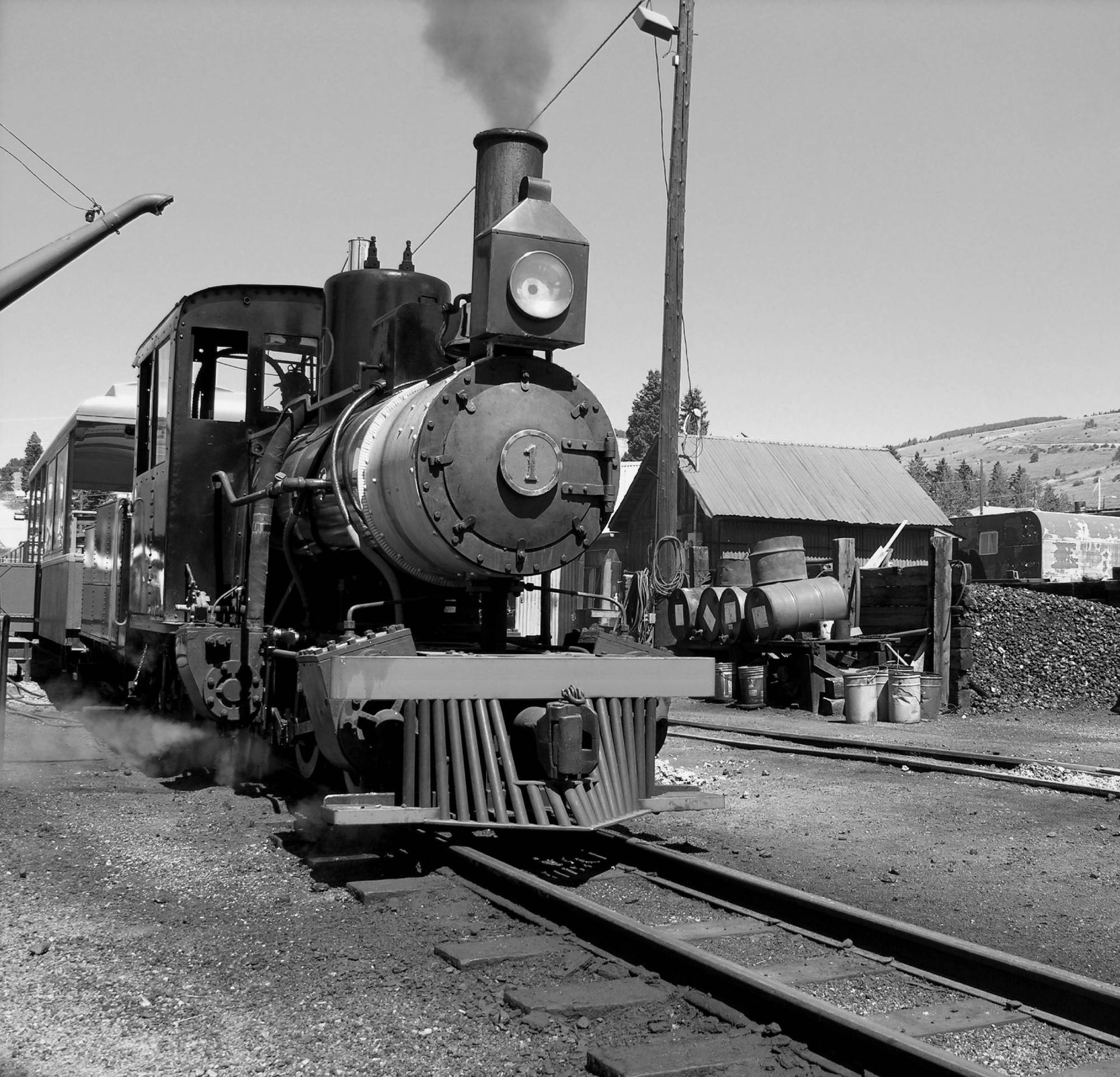 A black and white photo of a train on the tracks