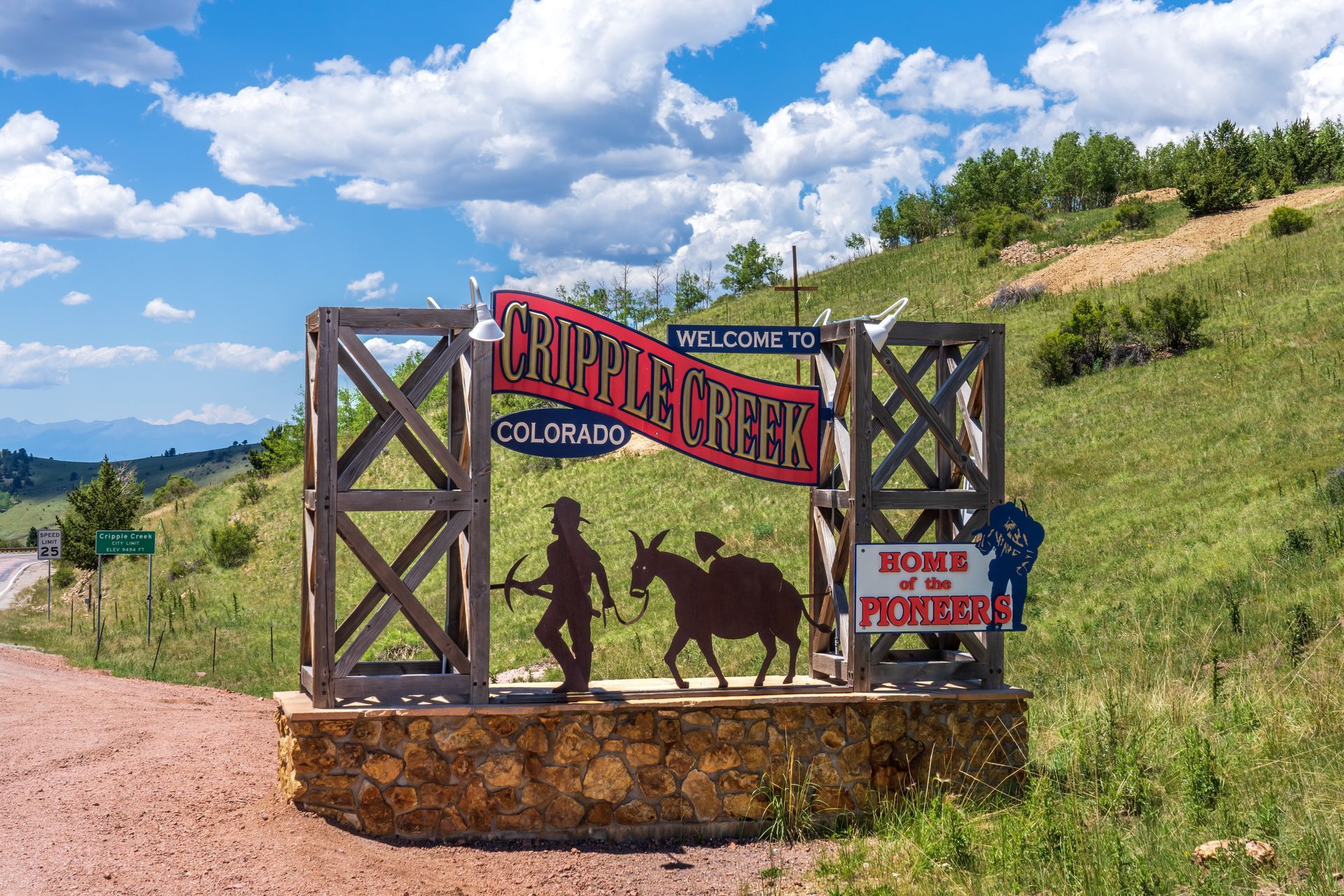 A sign that says `` welcome to chippewa creek '' is on the side of a dirt road.