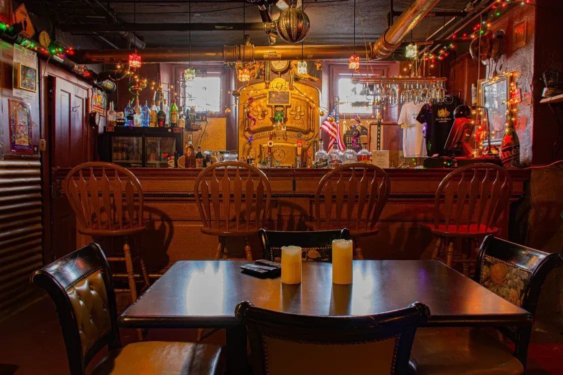 A restaurant with tables and chairs and candles on the table.