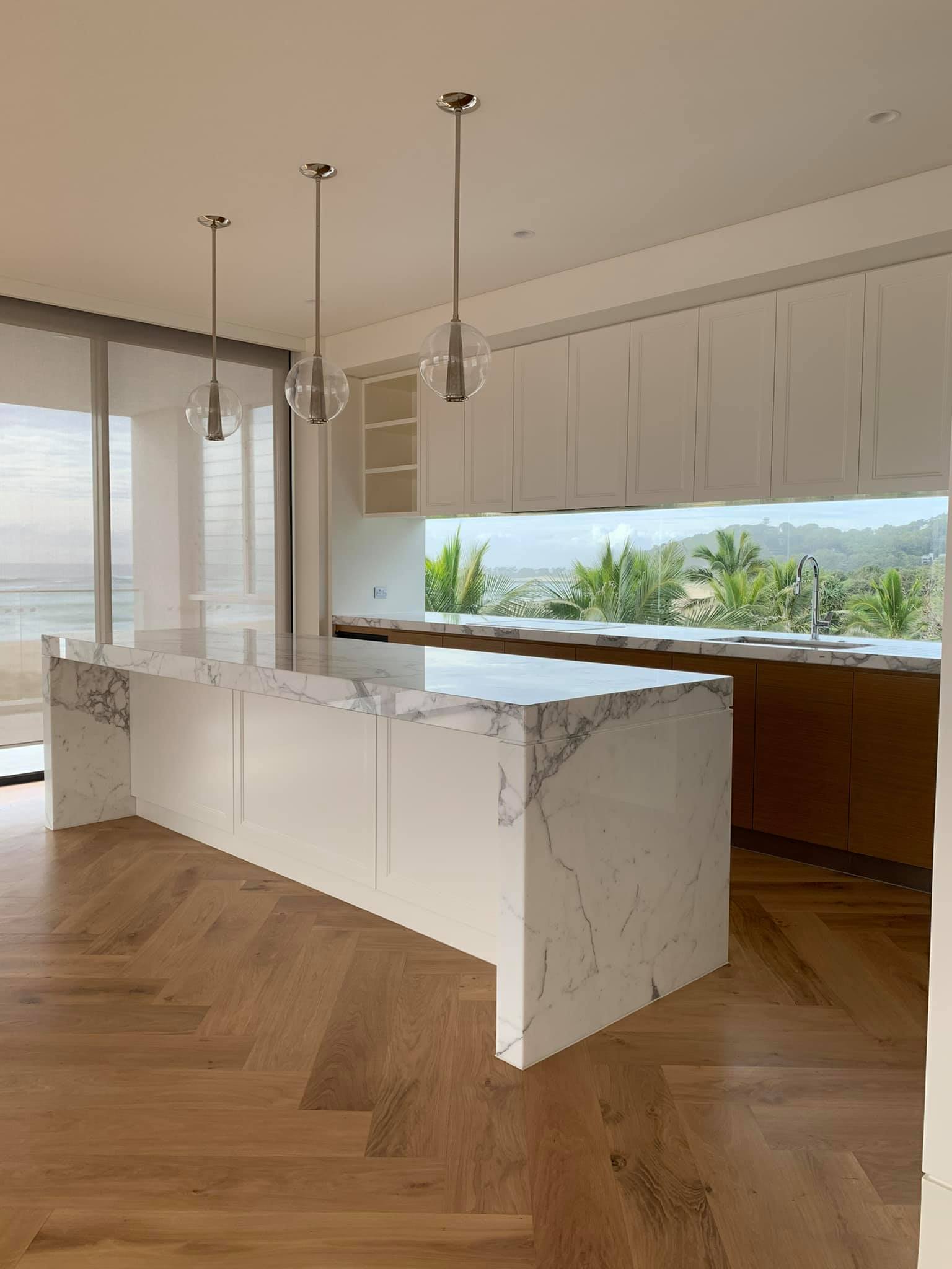 Modern White Kitchen Cabinets With Beach Outlook — Interior Design in Tweed Heads, NSW