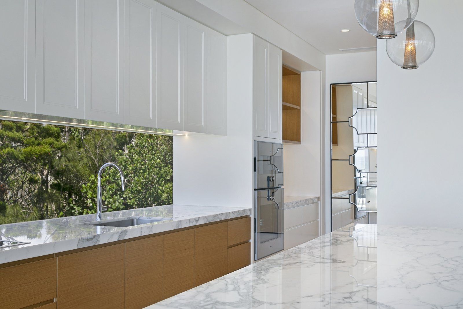 Custom Kitchen Cabinets with Marble Benchtop and Wooden Features — Interior Design in Tweed Heads, NSW