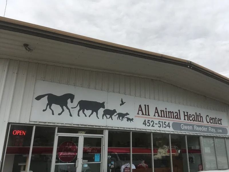 All Animal Health Center storefront with animal silhouettes and business details.