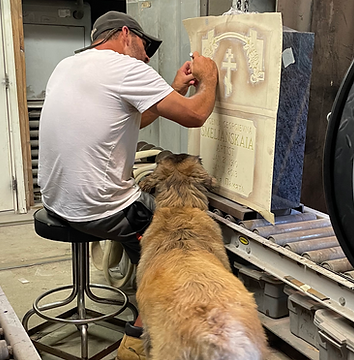 Worker preparing headstone for computer etching