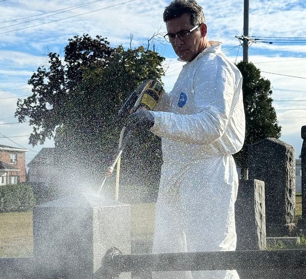 cleaning a tomb stone