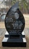 Teardrop-shaped headstone of polished black granite with lased-etched image of the deceased.