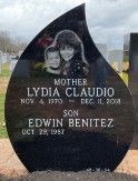 Black teardrop-shaped tombstone with a laser-etched image of a woman and her child.