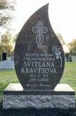 Dark granite teardrop-shaped headstone with etched cross and rose. Inscriptions: