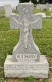 A two-part grey granite gravestone with a base and die. A Celtic cross includes an image of Jesus.