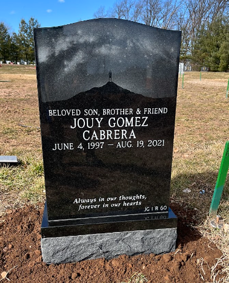 cleaning a cemetery gravestone