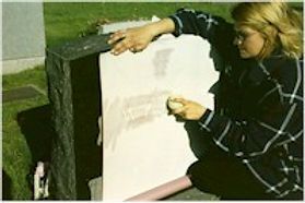woman engraving tomb stone
