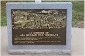 A bronze plaque set on granite honoring Korean War veterans. 