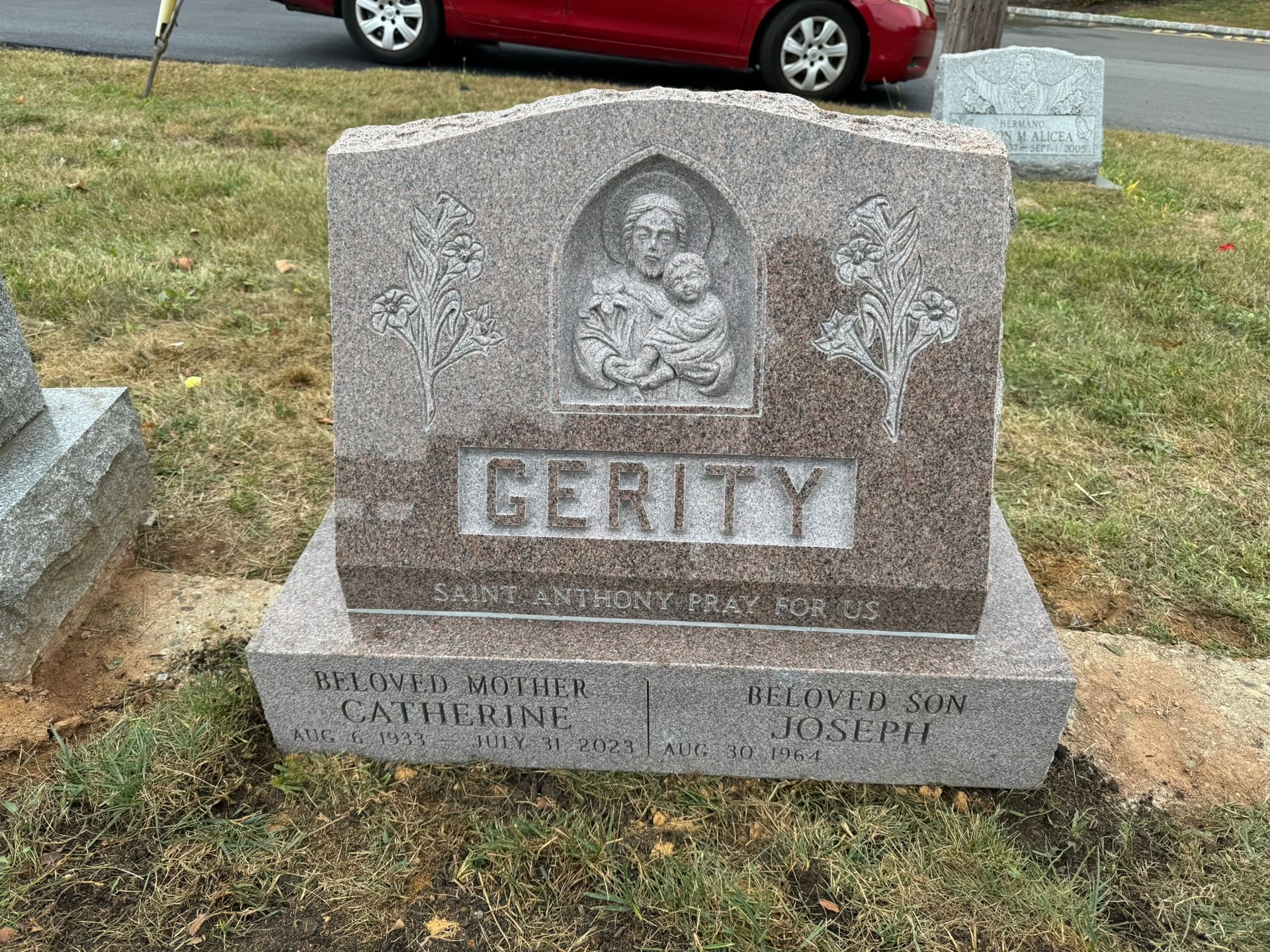 Gravestone with carved image of a saint holding a child,
