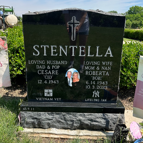 A gravestone for william and anna hao in a cemetery.