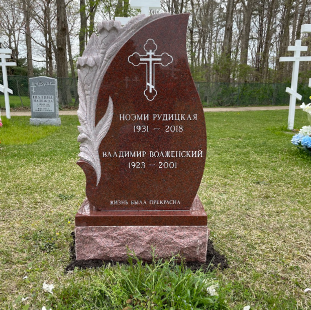 A double upright headstone for William and Julia Kistler with a cross and music notes.