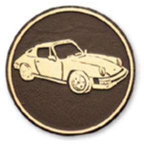 Bronze circular emblem featuring a detailed gold Porsche 911 car.