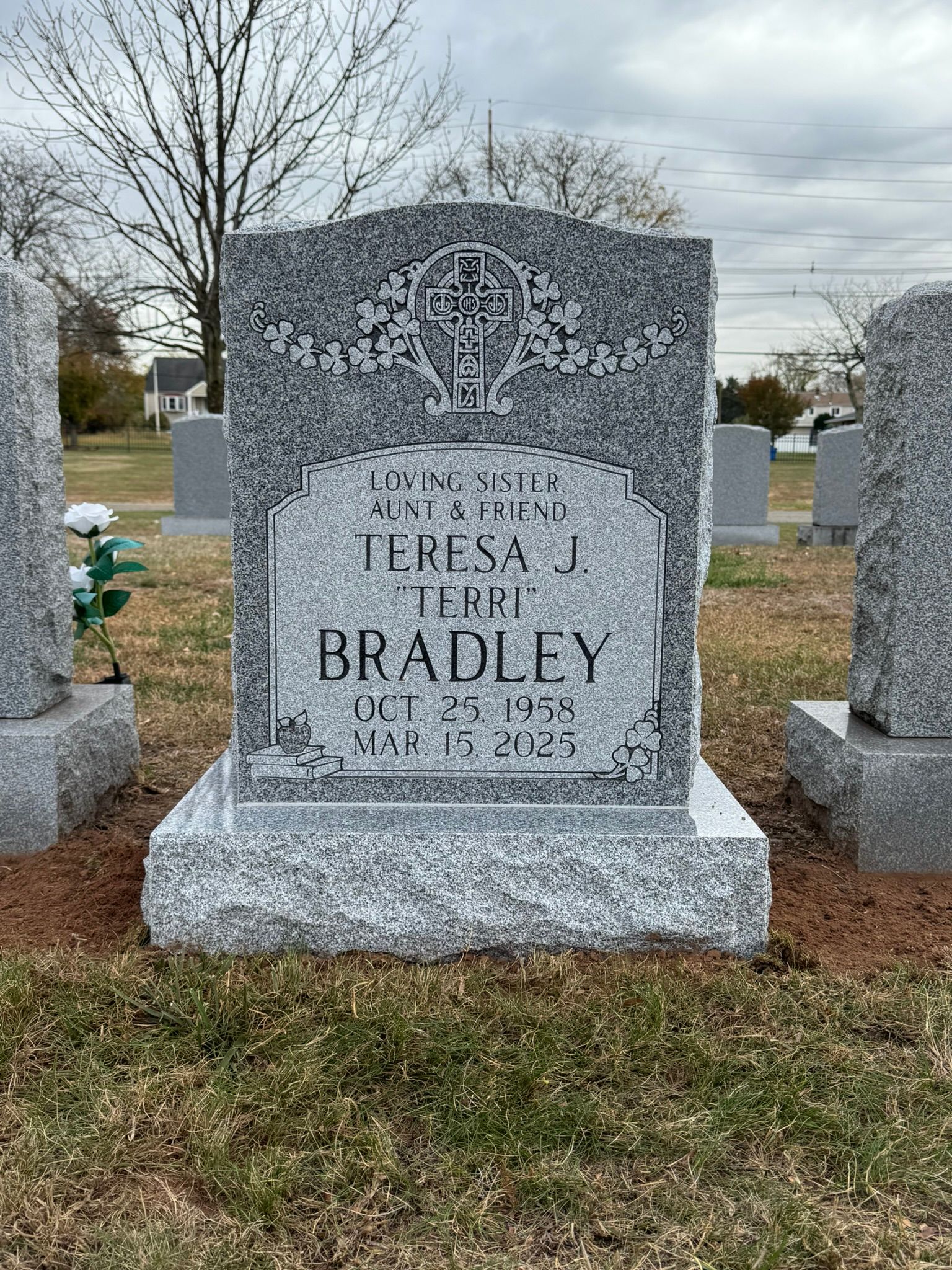 Gray granite headstone for Teresa J. Bradley in a cemetery.