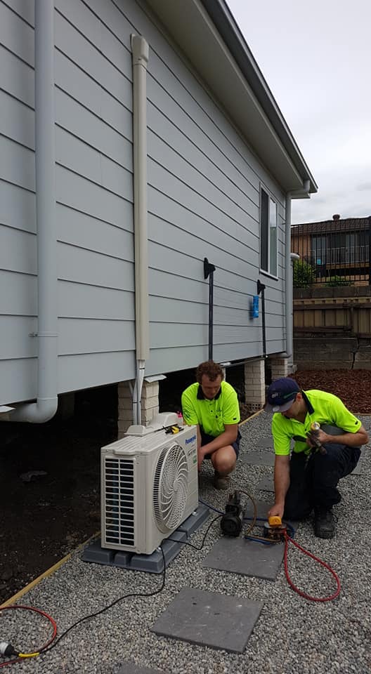 Technicians Fixing Air Condition — Newcastle Air & Refrigeration In New Lambton, NSW