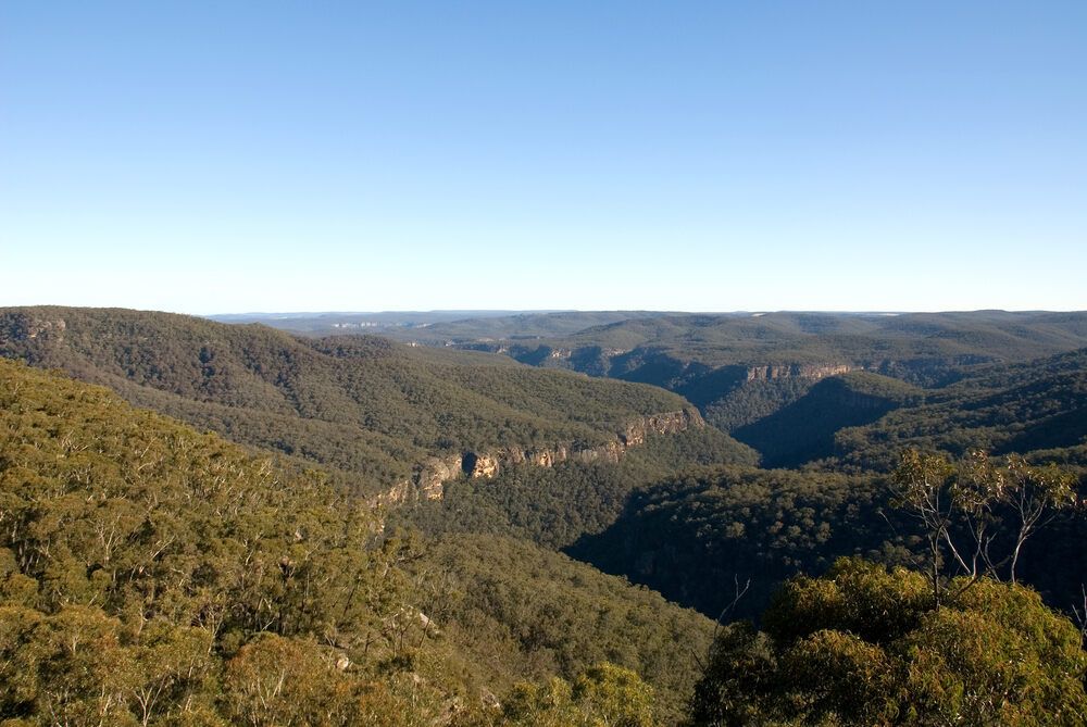 A View Of A Valley Surrounded By Mountains And Trees On A Sunny Day — Newcastle Air & Refrigeration In Cardiff, NSW