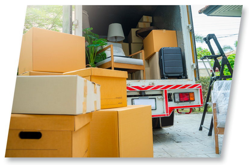 Boxes and furniture being loaded into a moving truck.