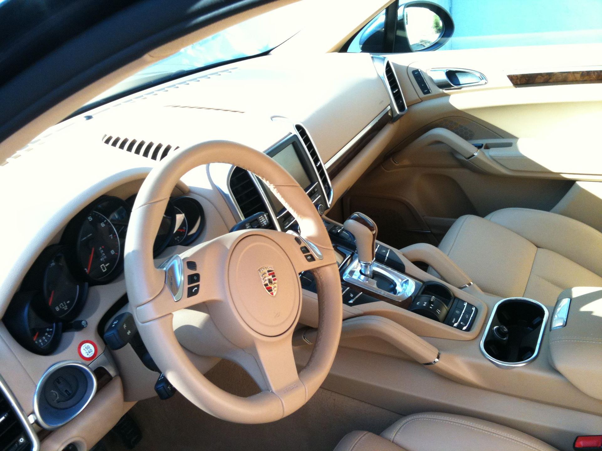 Black Ice Details & Coatings | The inside of a Porsche car with a steering wheel