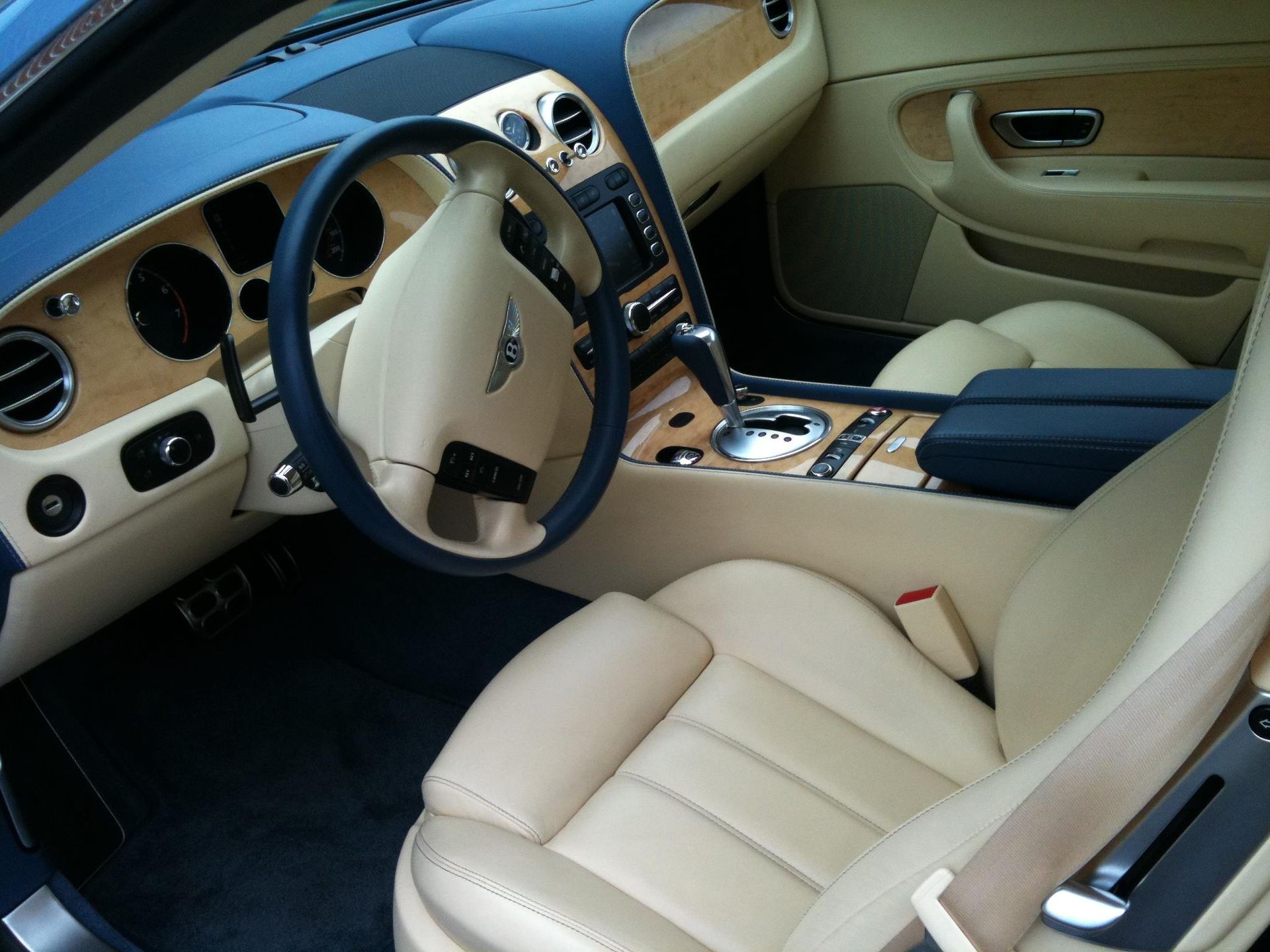 Black Ice Details & Coatings | The interior of a Bentley car with tan leather seats