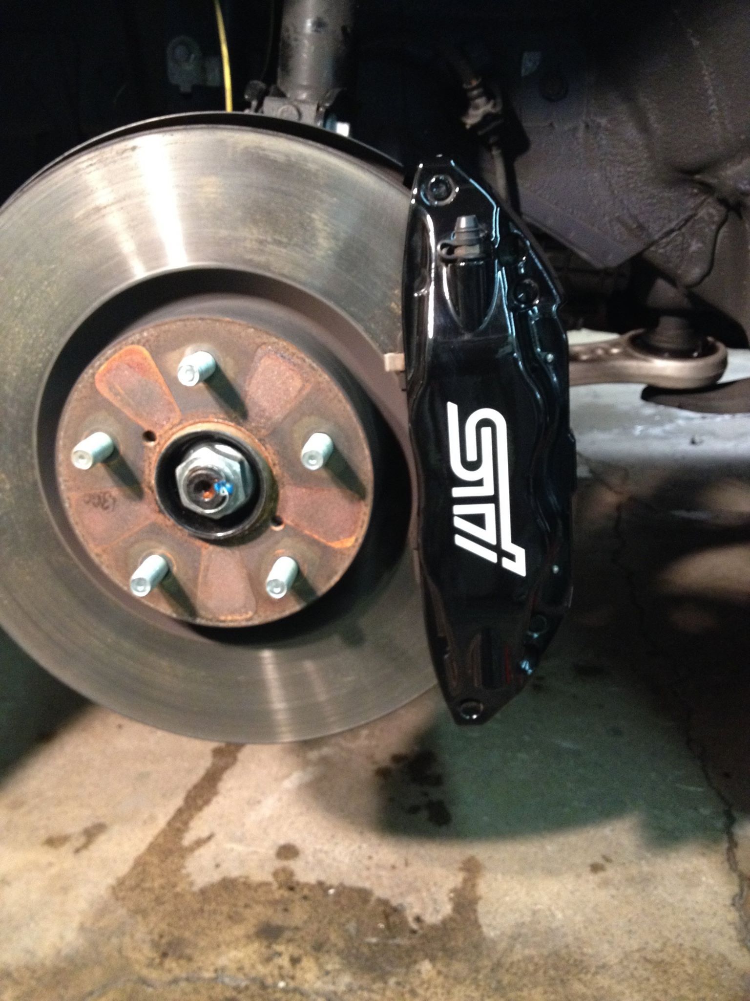 Black Ice Details & Coatings | close up of a brake disc on a car.