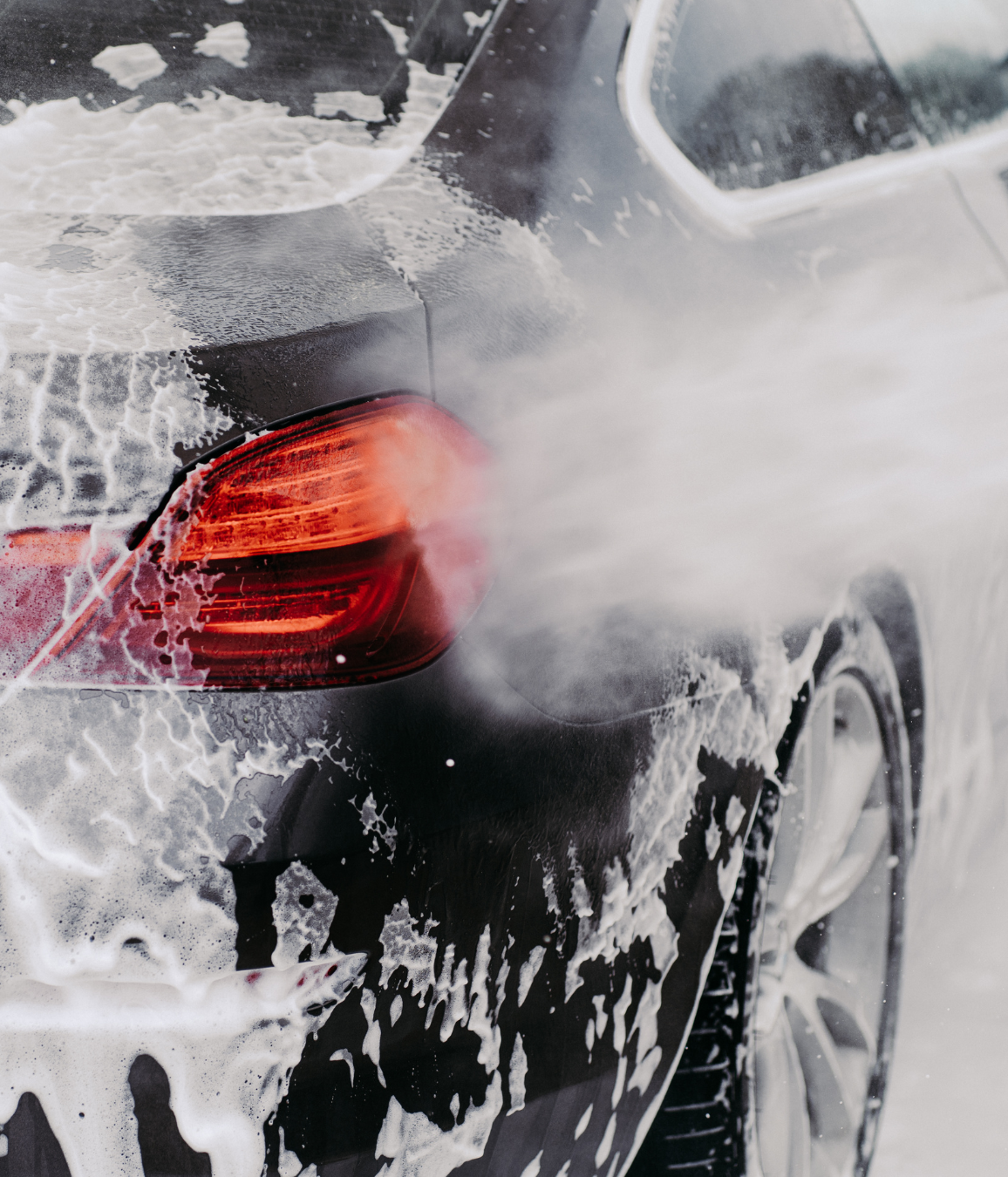 Black Ice Details & Coatings | black car is being washed with soap and water