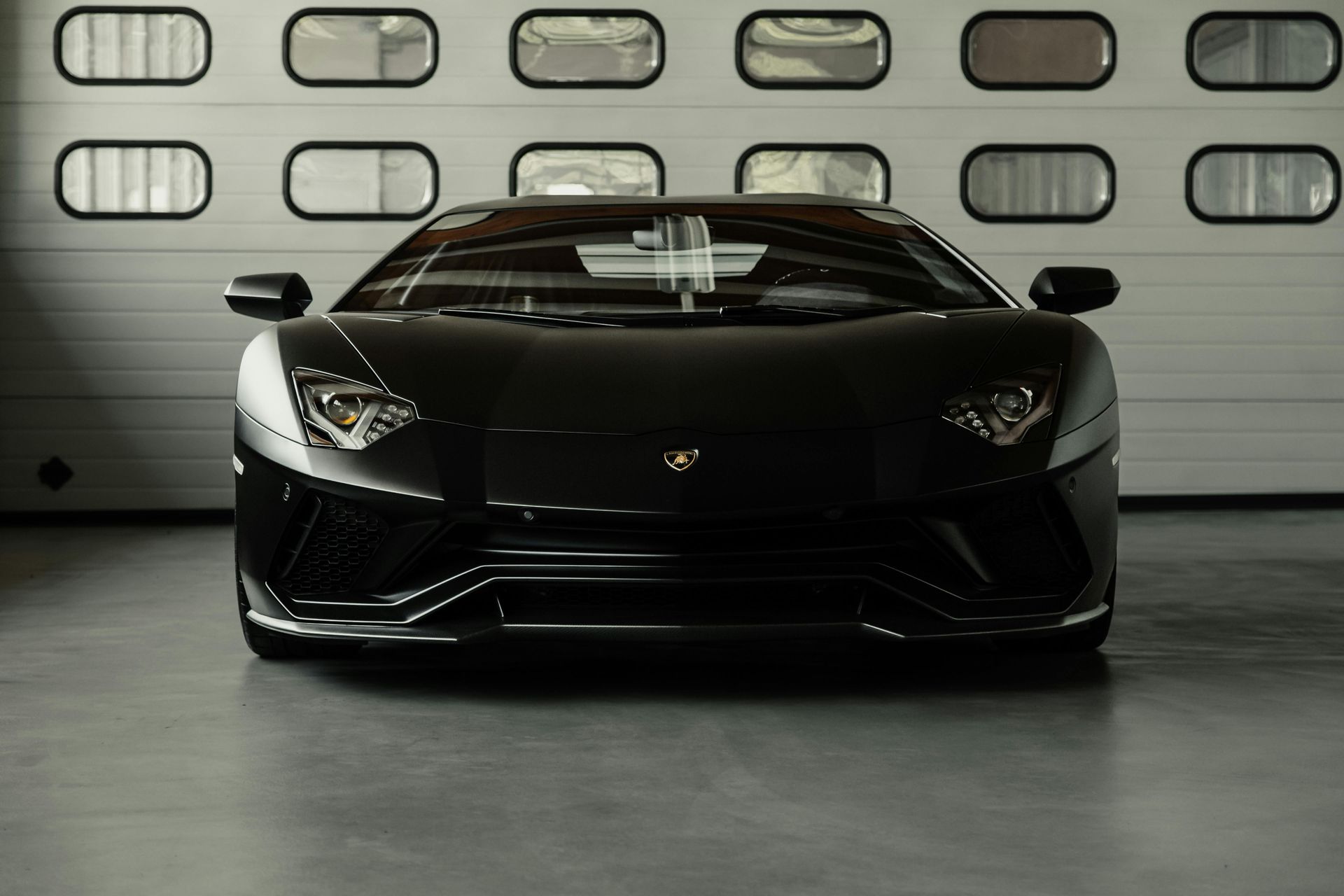 A concrete garage floor with a car on top