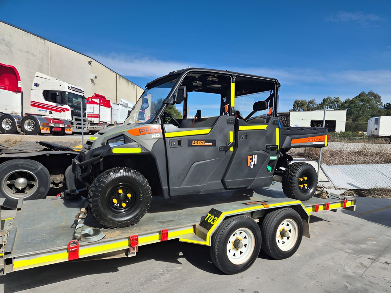 A Utility Vehicle Is Sitting On Top Of A Trailer  — Forcequip Hire In Southside, QLD