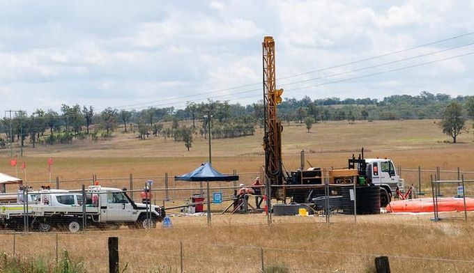 A truck is parked in a field next to a drilling rig — Forcequip Hire In Southside, QLD