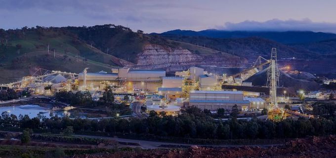 An aerial view of a large industrial area with mountains in the background at night — Forcequip Hire In Southside, QLD