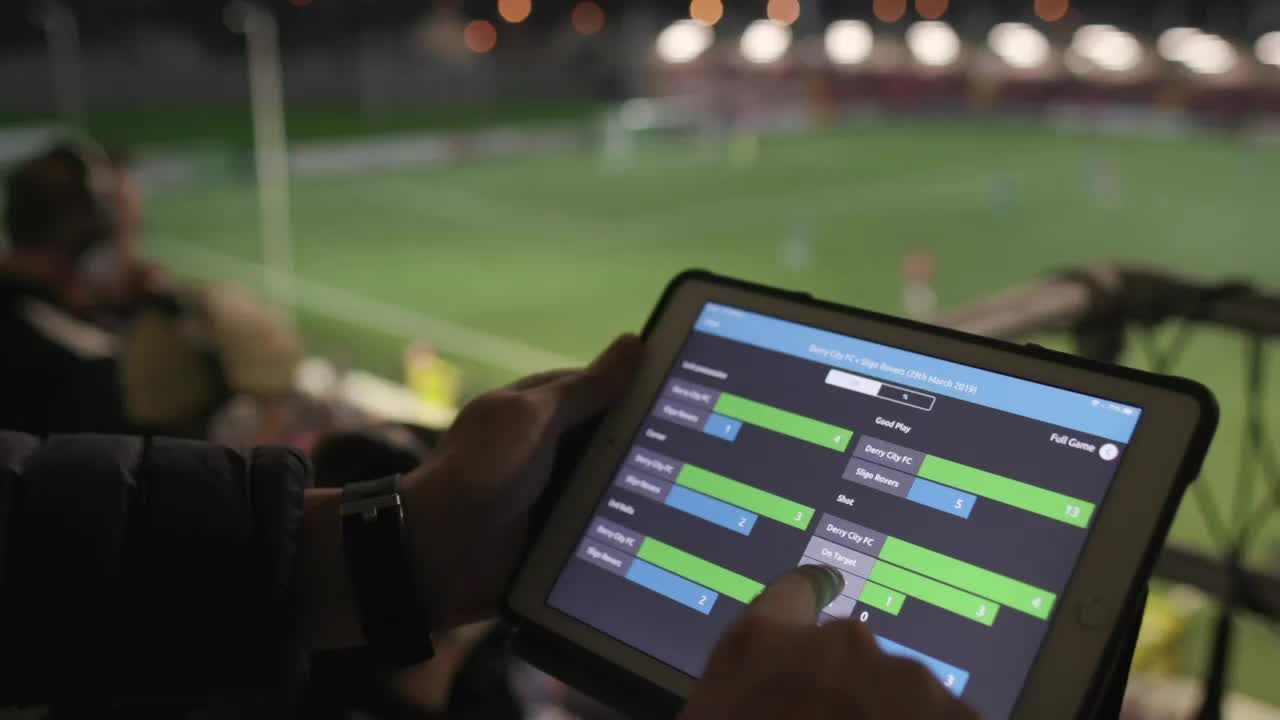 Coach guiding athletes using performance data and smart technology in a U.S.-based sports training environment