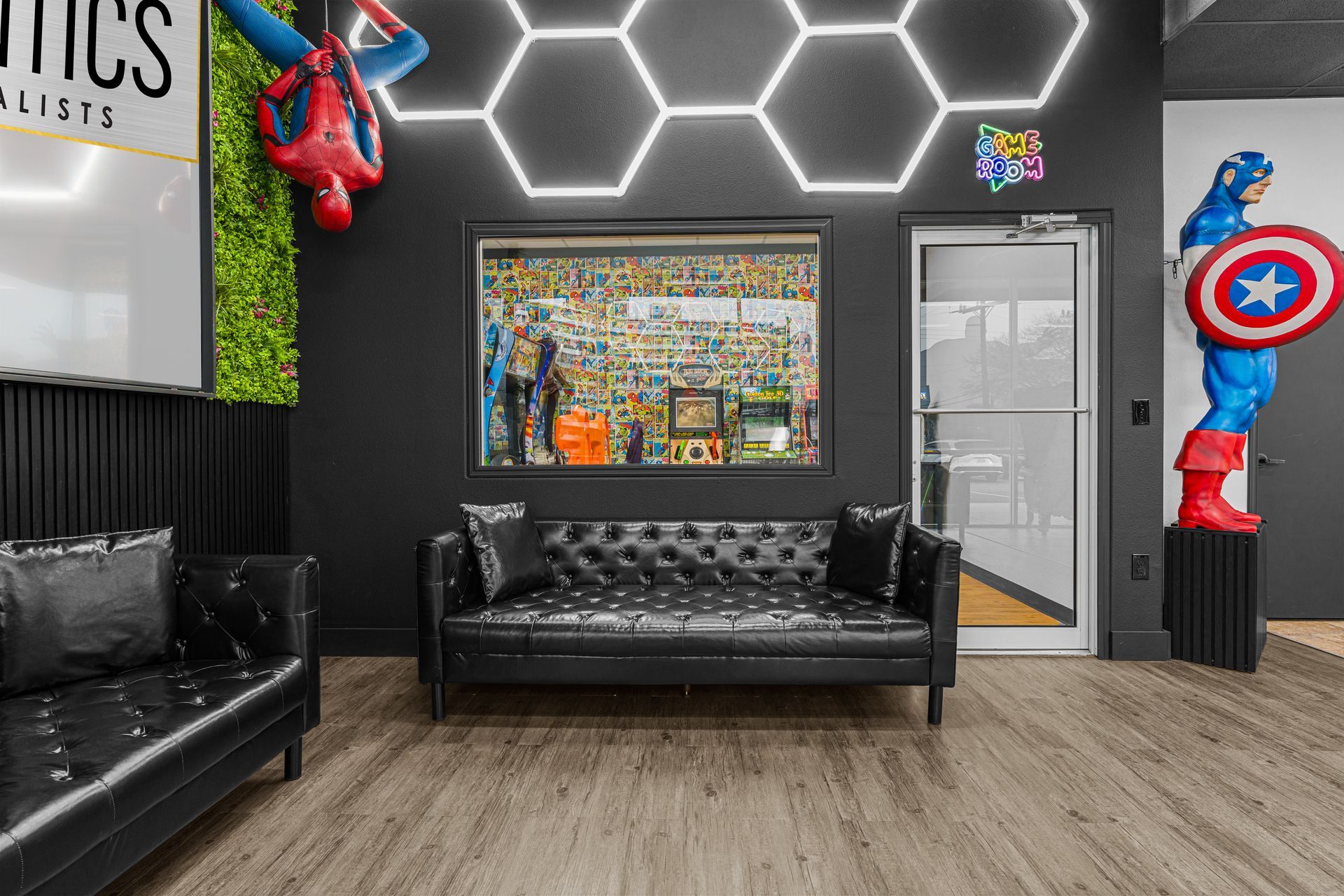 Lucent Orthodontics, San Antonio. A modern waiting area with black leather couches, a Spider-Man figure on the ceiling, and Captain America by a door.