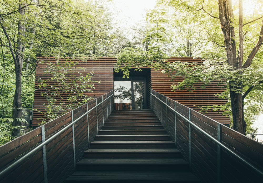 Large wooden stairs leading to the entrance of Balnea Spa + Thermal Reserve.