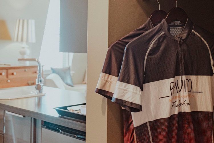 A couple of shirts are hanging on a wall in a room.