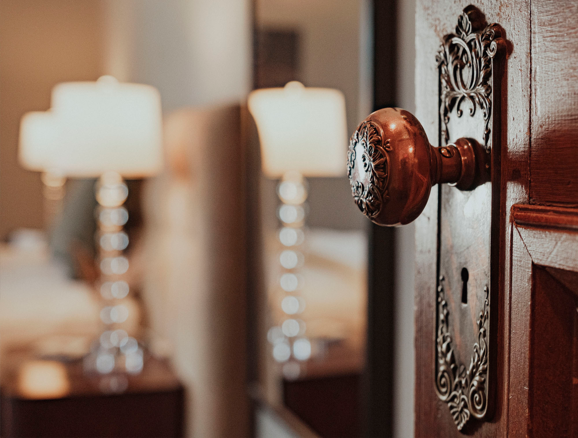 A close up of a door knob on a wooden door.