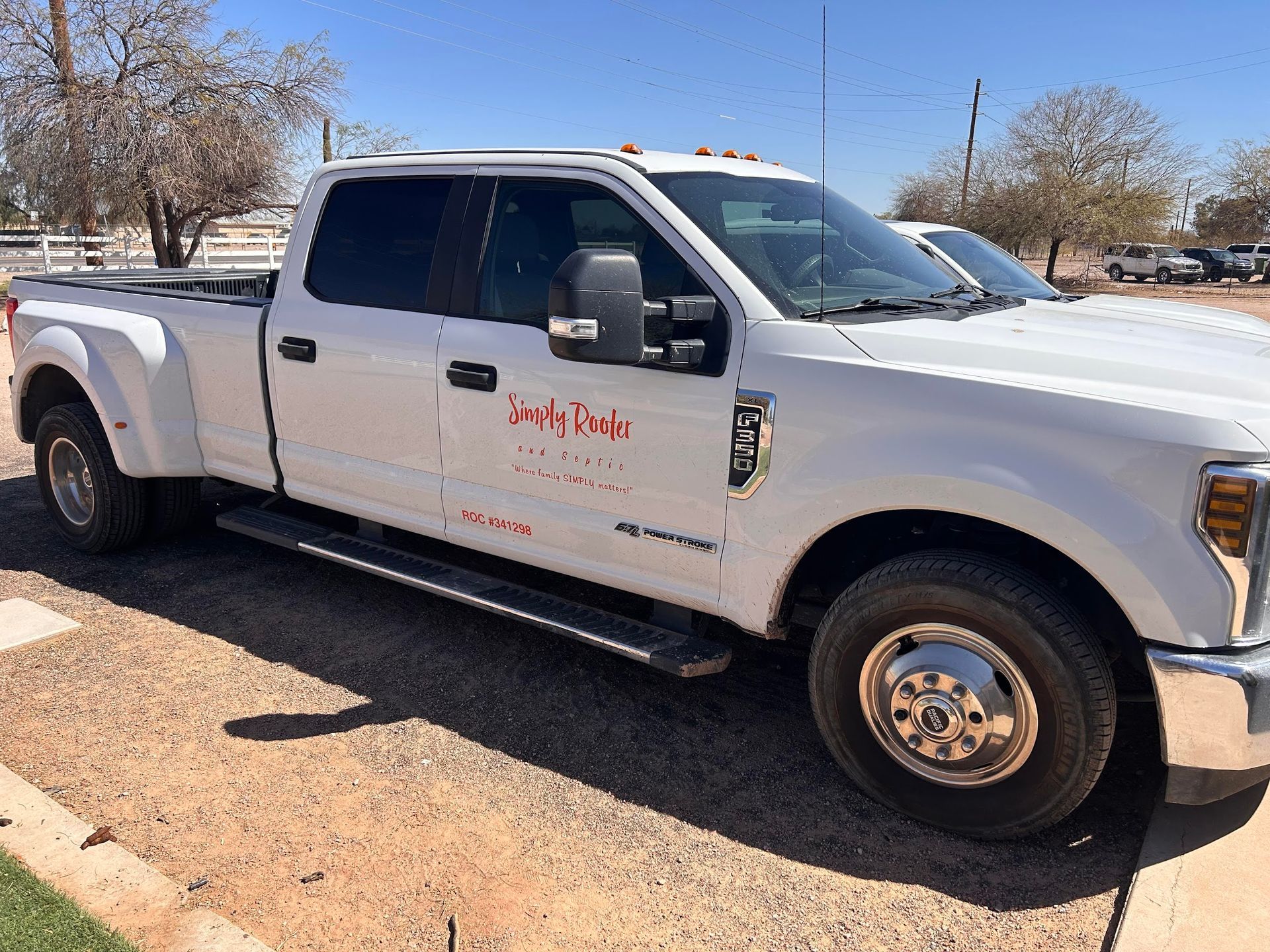 White pickup truck parked outdoors on a sunny day.