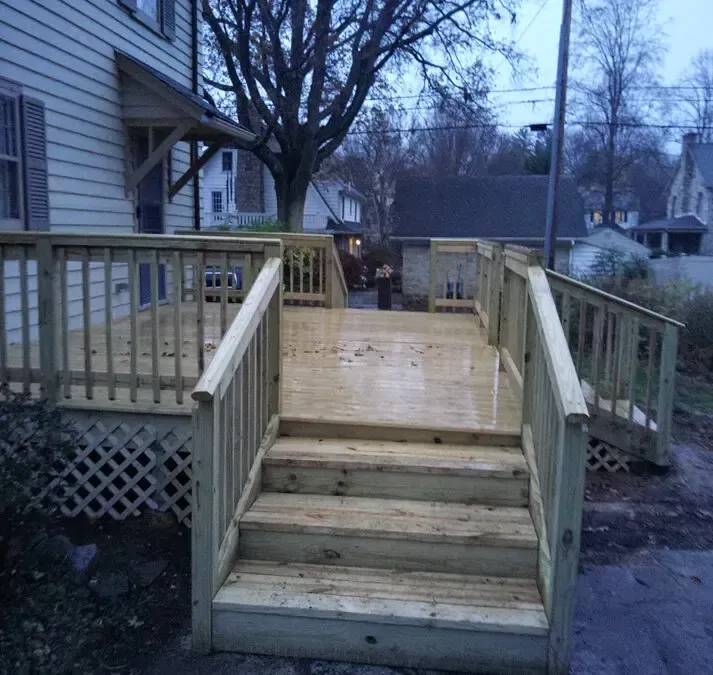 A wooden deck with stairs leading up to it