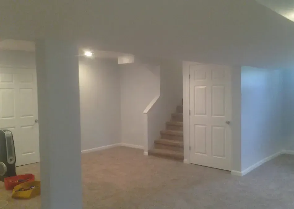 A basement with stairs leading up to the second floor.
