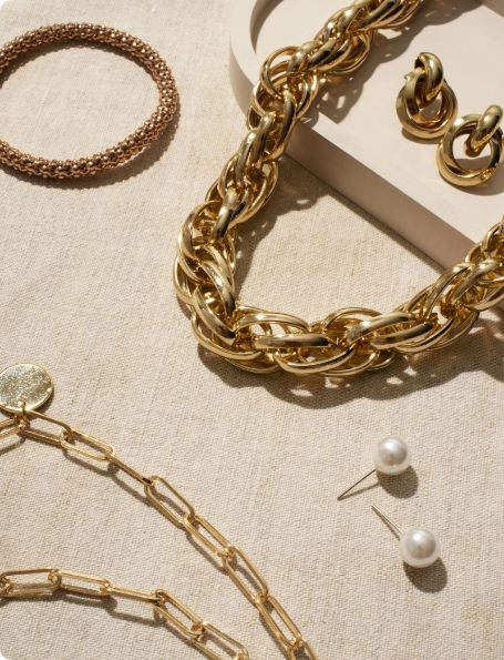 A necklace bracelet and earrings are on a table