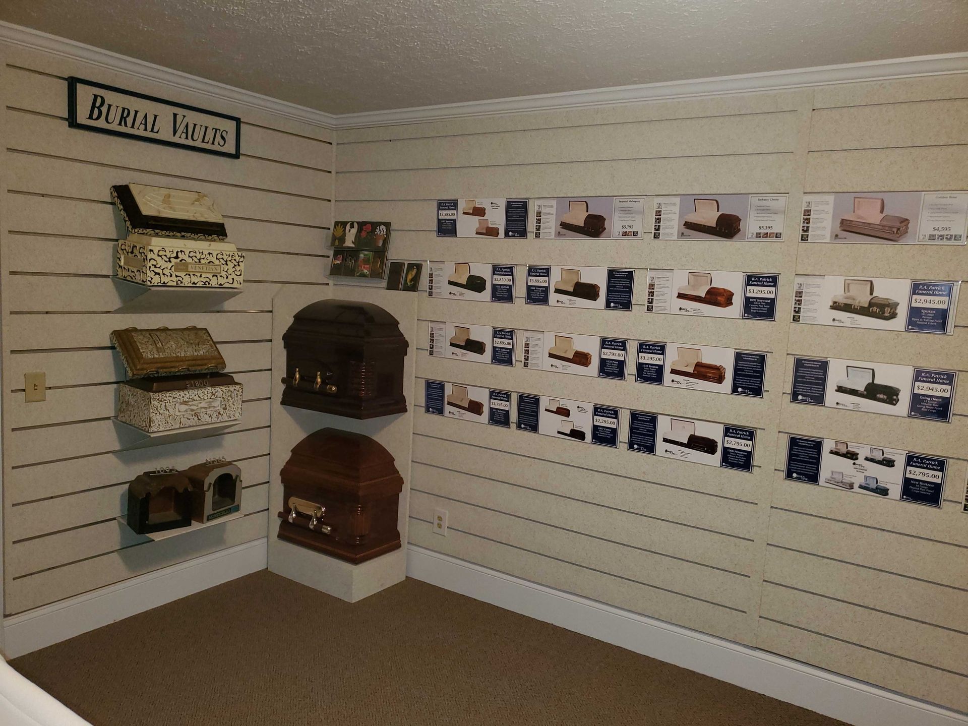 Interior room with display of urns and brochures on a slatted wall.