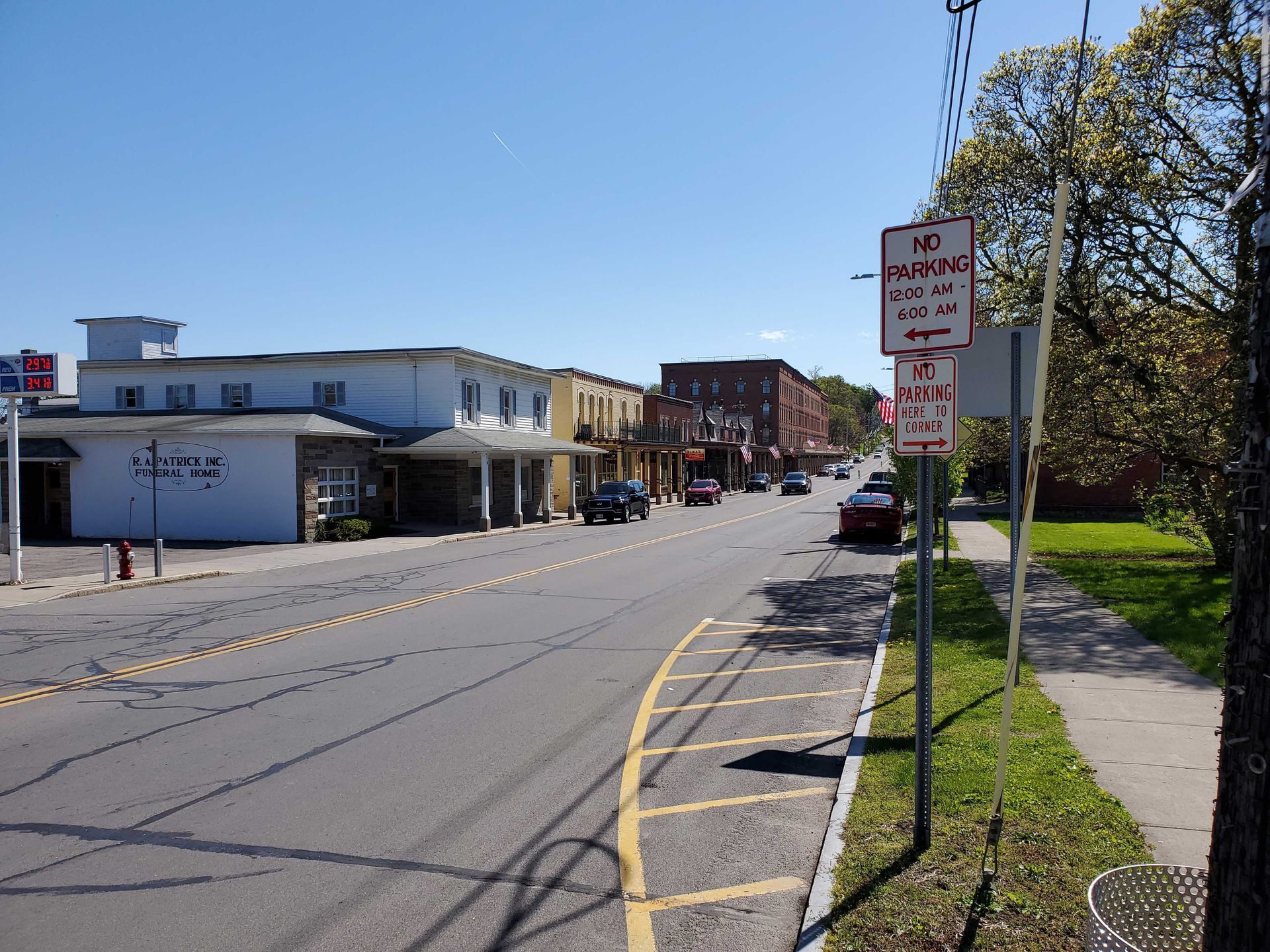 Street with parked cars, buildings, and 