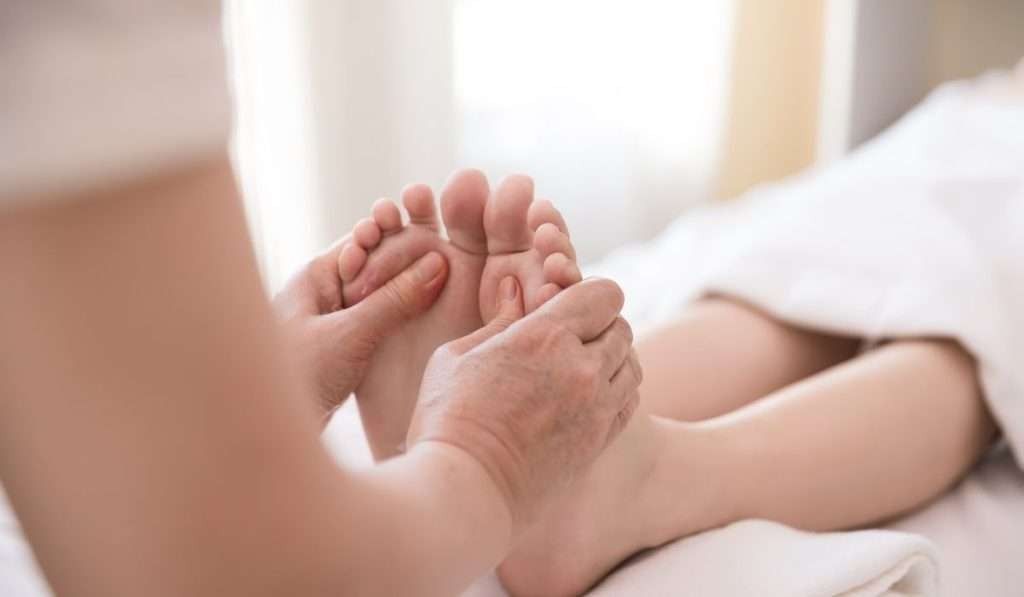 A Woman is Getting a Foot Massage in a Spa — Your Body Revolution in Caloundra, QLD